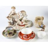 A continental porcelain group, a Victorian saltglaze jug, Spode cup and saucer,