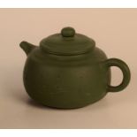 A Chinese Yixing green teapot, calligraphy to the rear, height 9.5cm, width 15.5cm.