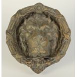 A large brass lion door knocker. Condition report: Back plate 20cm diameter.