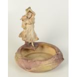 An Art Nouveau Amphora Pottery figural dish, modelled with a girl, height 20cm, diameter 18cm.