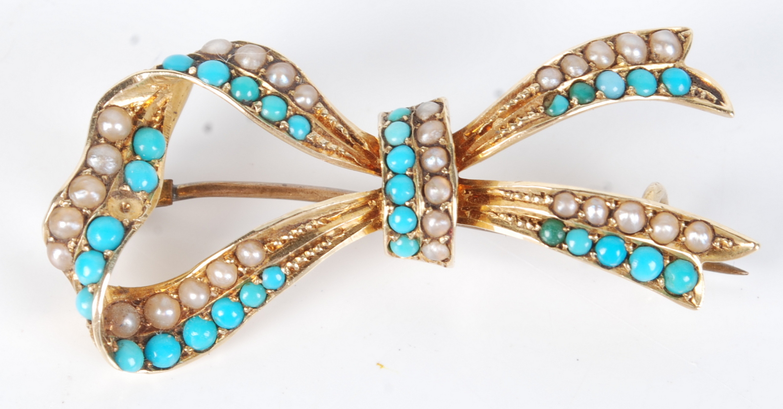 A 15ct gold bow brooch set with half pearls and turquoise, boxed.