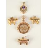 Three 9ct gold animal charms, a late Victorian 9ct gold swastika fob and a gold pendant, 7.4g.