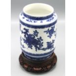 A Chinese blue and white vase of cylindrical form supporting sloping shoulders and short vertical