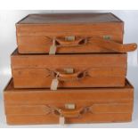 A set of three Hartman tan leather suitcases, inscribed H-65, H-30 and H-44,