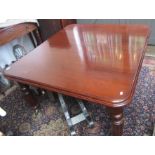 A Victorian mahogany extending dining table, the rectangular moulded top on turned and fluted legs,