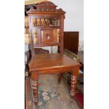 A late Victorian walnut hall chair, height 100cm, width 47cm.