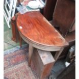 A George III mahogany demi lune card table, the moulded fold over top on square tapering legs,