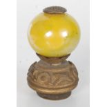 A Chinese gilt metal and yellow glass hat finial, circa 1900, with shou and floral decorated mounts,