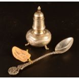 A Chinese silver pepper pot together with a Russian silver spoon.