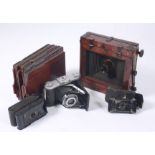 A mahogany folding plate camera, an Ensign Ranger Special camera,