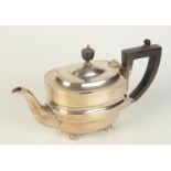 A plain silver bachelors teapot with turned ebonised urn finial by Fordham & Faulkner,