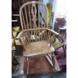 An elm Windsor rocking chair, 19th century, with a pierced central splat and spindle filled back,