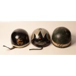 A Triumph wooden motorbike helmet and two others.