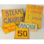 Five painted amusement signs.