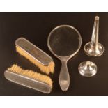 A silver and tortoiseshell hand mirror, a pair of matching brushes and a silver spill.
