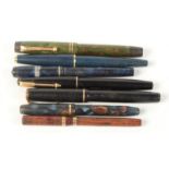 Seven small fountain pens.