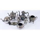 A silver plated three piece tea set, a four piece set and an inkstand.