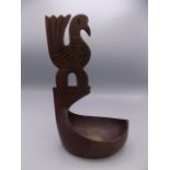 A Scandinavian treen bowl, the handle in the form of a stylised bird, height 26cm, width 16cm.