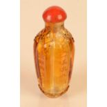 A fine 18th century Peking yellow glass carved and inscribed snuff bottle of hexafoil section,