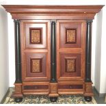 A German oak and ebonised armoire, 19th century, Hamburg, with a pair of panelled doors,