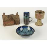 Two pieces of Newlyn Pottery, a Tremar Pottery goblet and money box entitled 'The Miners Arms'.