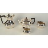 A silver plated four piece tea set, with ebonised handles and gadrooned body.