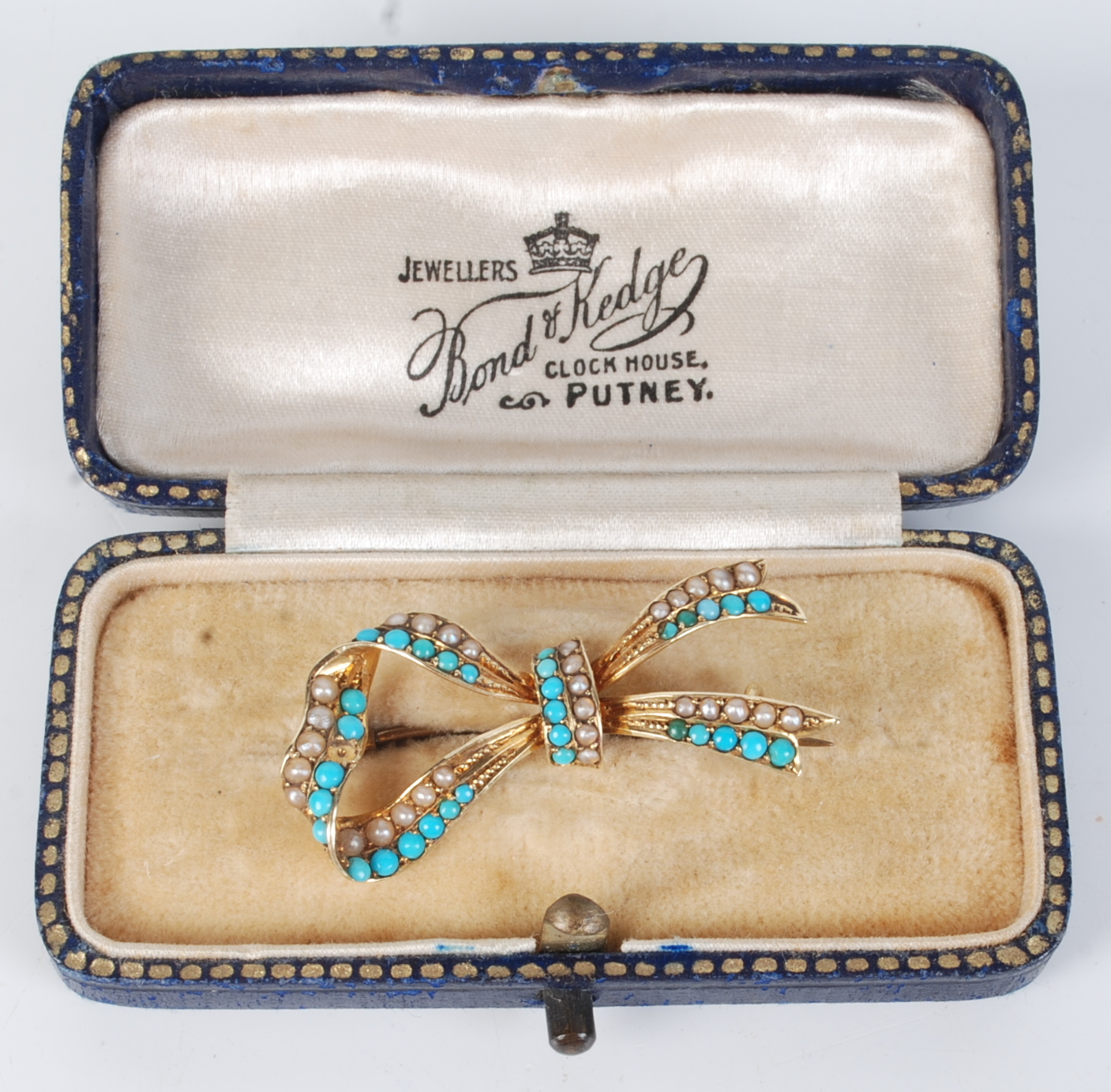 A 15ct gold bow brooch set with half pearls and turquoise, boxed. - Image 2 of 2