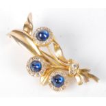 A good gold spray brooch mounted with three diamond and cabochon sapphire clusters, length 48mm, 7.