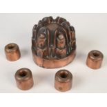 A Victorian copper six turret jelly mould, together with a set of four miniature copper moulds.