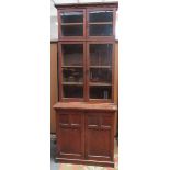 An Arts and Crafts oak bookcase, with four glazed doors,