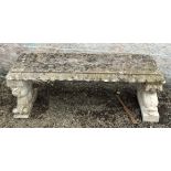 A composition garden bench with stylised dolphin supports, height 46cm, width 122cm, depth 39cm.