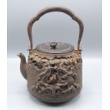 A Japanese iron kettle, Meiji period, the bronze cover with incised signature.