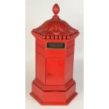 A country house post box in red painted oak by Lenny Murrell height 59cm, width 31cm.