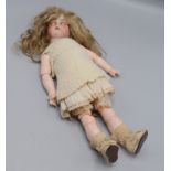 A doll with a bisque porcelain head, articulated arms and legs, length 34.