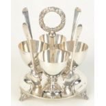 A Victorian silver four section egg cruet the central handle with laurel wreath finial by Mappin &