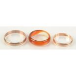 Two low purity gold bands and an agate ring.