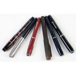 A black fountain pen with Duroid nib, an Esterbrook red fountain pen, a black Esterbrook pen,