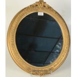 An oval framed gilt composition wall mirror, early 20th century, 54 x 45.5cm.