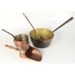 A copper saucepan, a brass preserve pan, a copper scoop and a copper ladle.