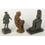 Two museum replica figures and a soapstone carving of a lizard.