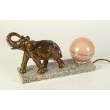 A French Art Deco elephant mounted table lamp, with globular shade on a marble plinth, height 20cm,