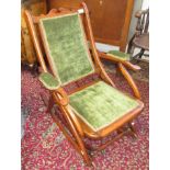 An Edwardian metamorphic beech rocking chair, green velvet upholstered back, arms and seat,