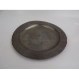 A pewter charger, early 20th century, with London touch marks, diameter 38cm.
