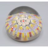 A millefiori glass paperweight, with latticello and multicoloured canes, height 5.5cm, diameter 7cm.