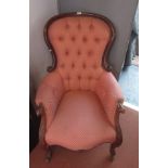 A Victorian mahogany gentleman's armchair, with a button upholstered padded back,