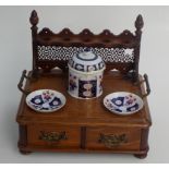 A late Victorian oak pipe rack, to fit five pipes, with a pair of pair of brass carrying handles,