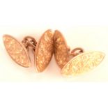 A pair of 9ct. gold cufflinks with engraved scrolling decoration, 6.7g.