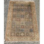 A Ghom Persian rug, with ten rows of five square sections,