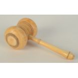 A turned ivory gavel, late 19th century, height 6cm, length 13cm.