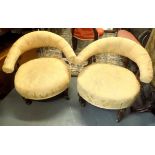 A pair of Victorian upholstered tub armchairs, on turned and fluted tapering front legs.